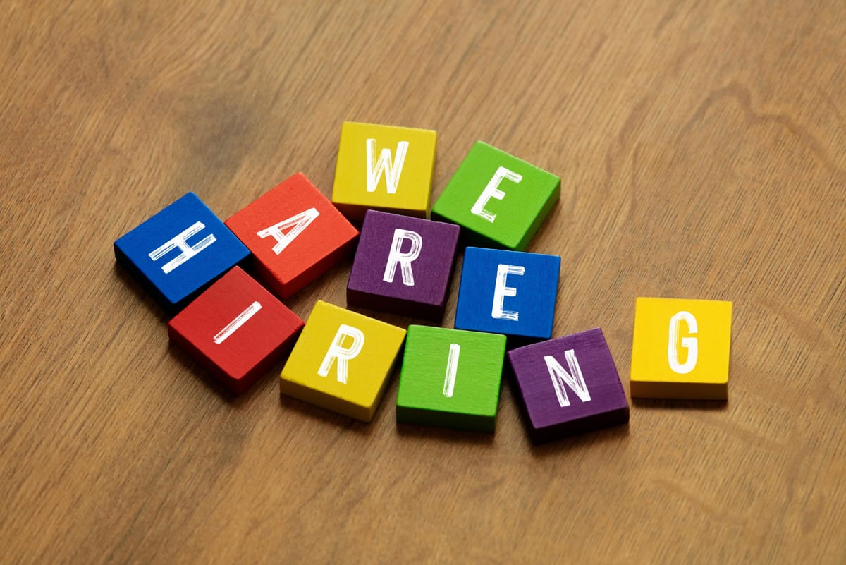 Wooden letter blocks spelling “we are hiring”
